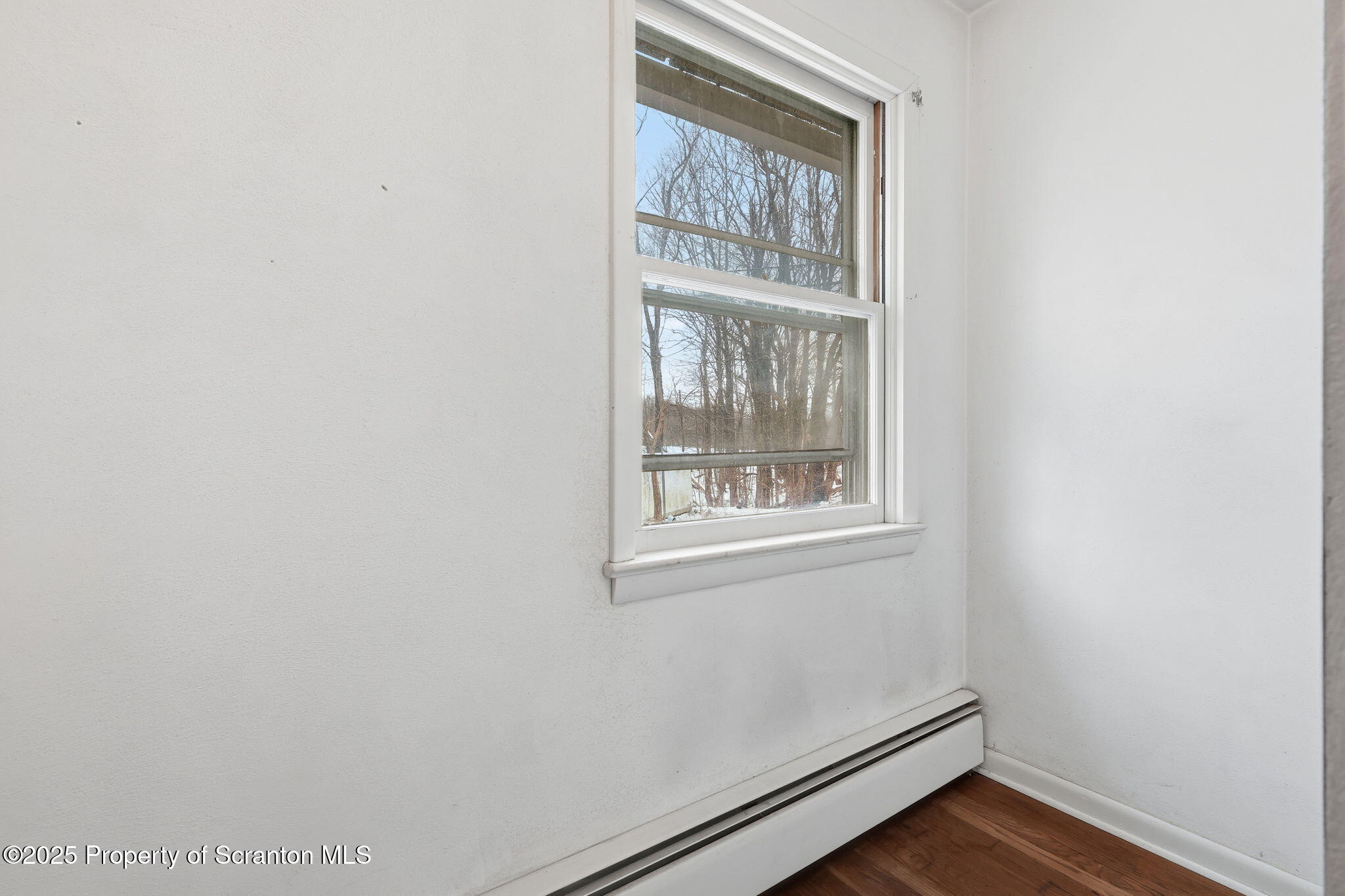 2457 Airport Road Forest City, PA 18421 - Photo 37 of 78 a view of an empty room with wooden floor and a window