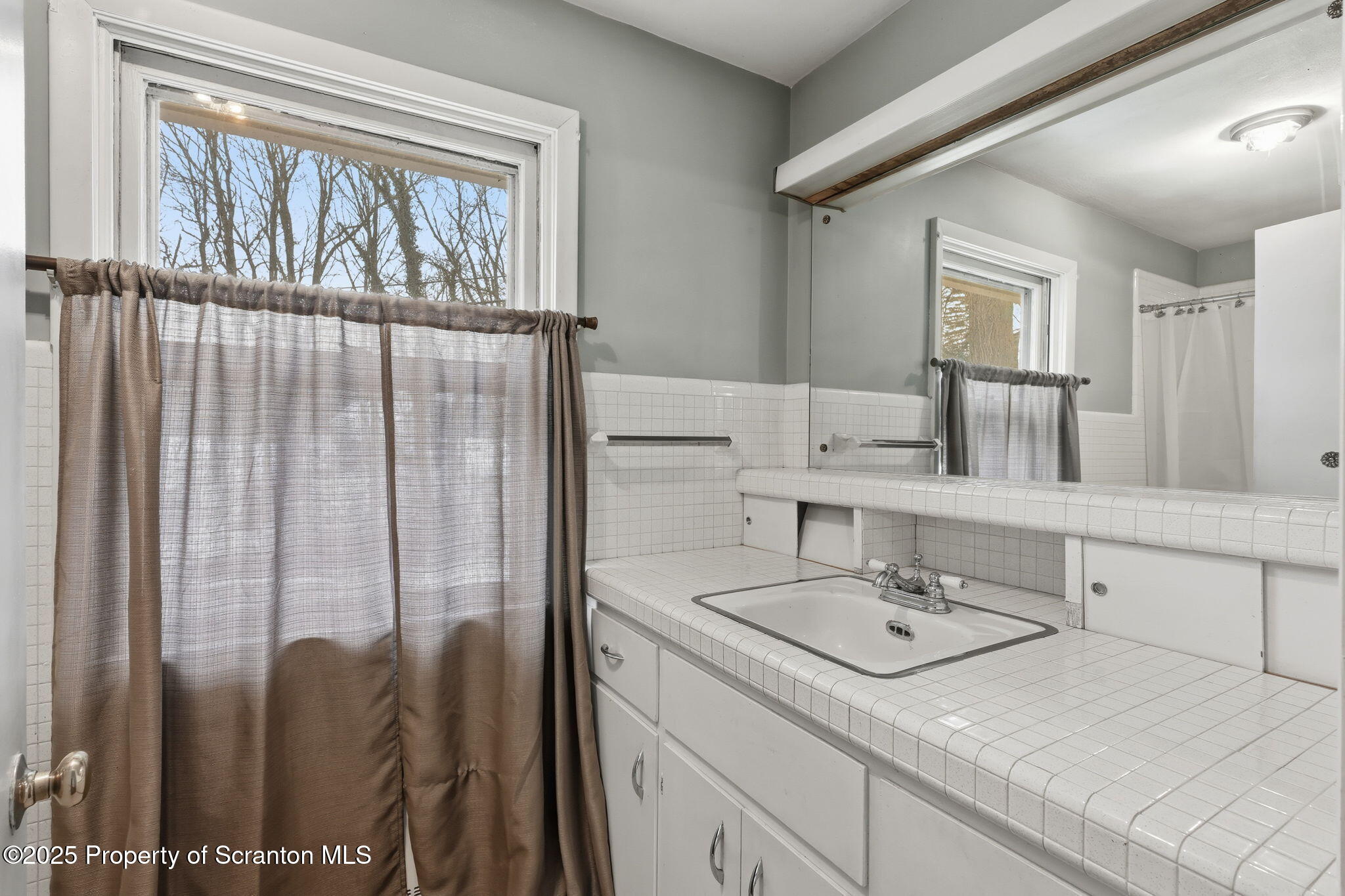 2457 Airport Road Forest City, PA 18421 - Photo 41 of 78 a bathroom with a sink and a mirror