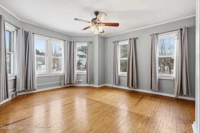 a view of a patio with a table and chairs under an umbrella