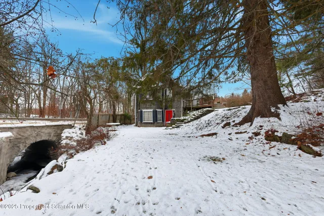a living room with furniture wooden floor and a large window