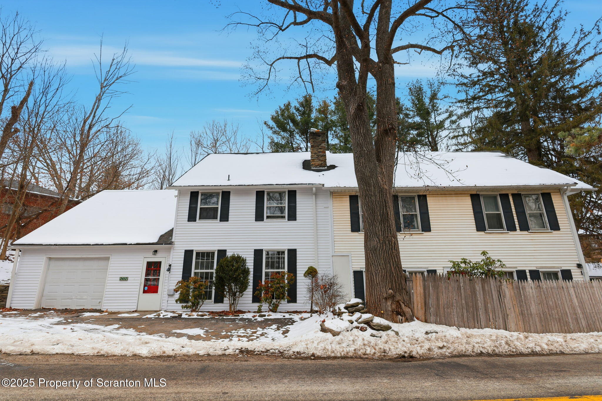 2457 Airport Road Forest City, PA 18421 - Photo 64 of 78 a view of a white house with a large tree and wooden fence