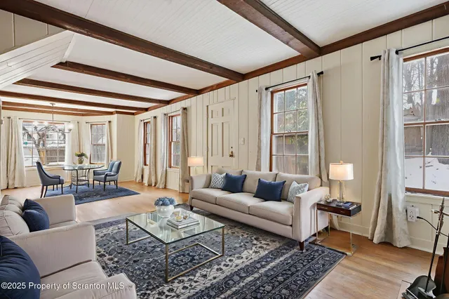 a living room with fireplace furniture and a flat screen tv