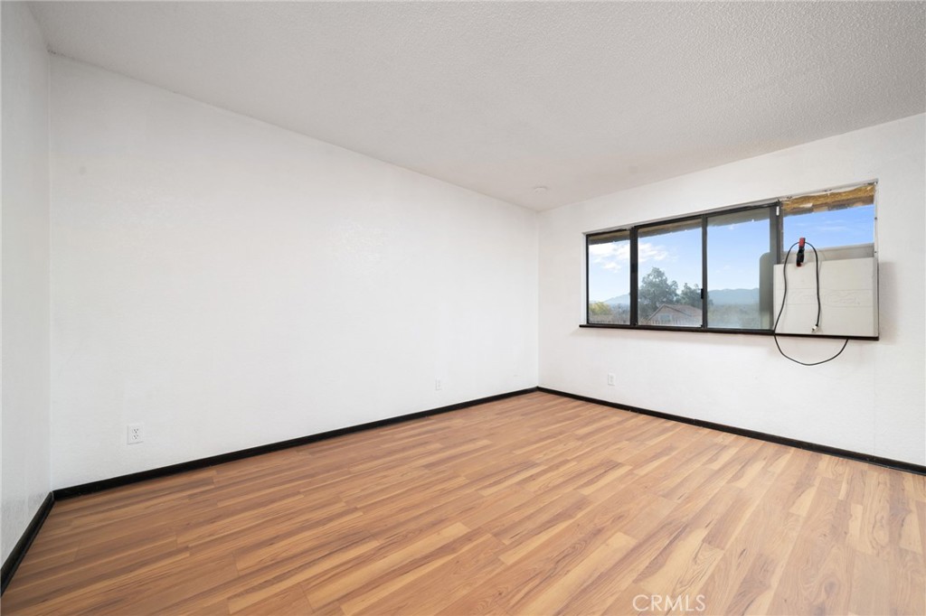 14580 Keota Road Apple Valley, CA 92307 - Photo 13 of 44 a view of empty room with wooden floor and fan