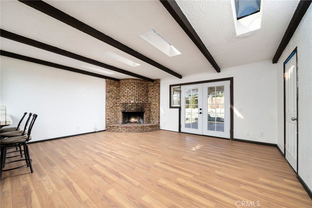 14580 Keota Road Apple Valley, CA 92307 - Photo 15 of 44 a view of an empty room with window and wooden floor