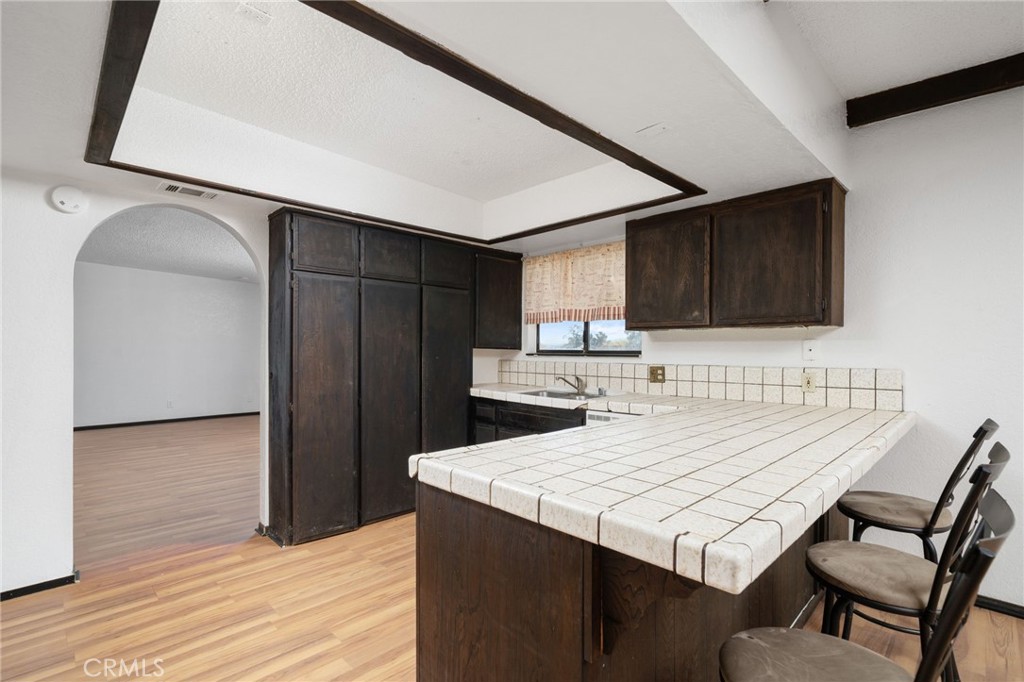14580 Keota Road Apple Valley, CA 92307 - Photo 18 of 44 a kitchen with a table chairs and refrigerator
