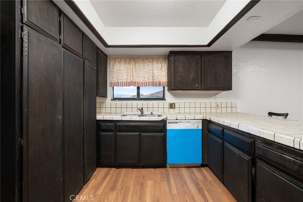 14580 Keota Road Apple Valley, CA 92307 - Photo 19 of 44 a kitchen with a sink and a window