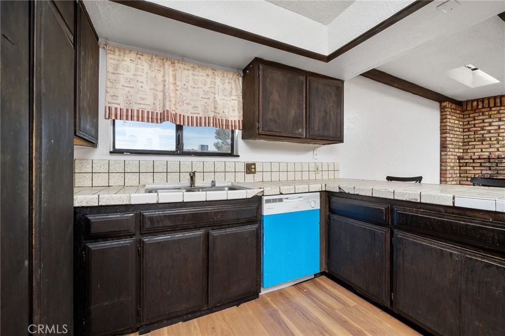 14580 Keota Road Apple Valley, CA 92307 - Photo 20 of 44 a kitchen with a sink stove and cabinets