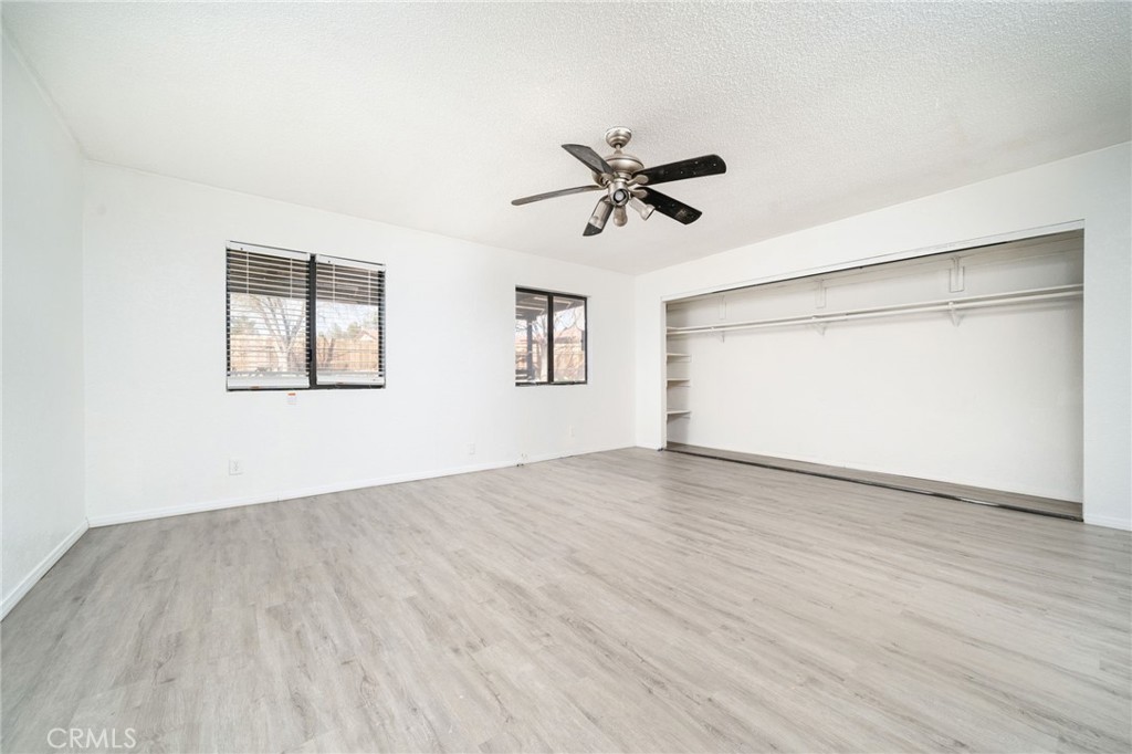14580 Keota Road Apple Valley, CA 92307 - Photo 25 of 44 a view of empty room with wooden floor and fan