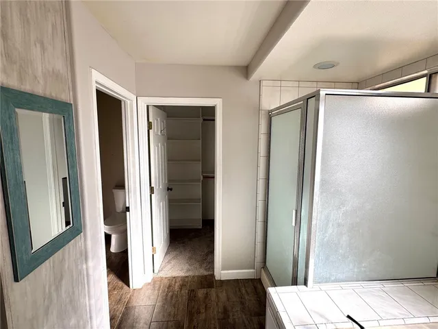 a view of hallway with wooden floor
