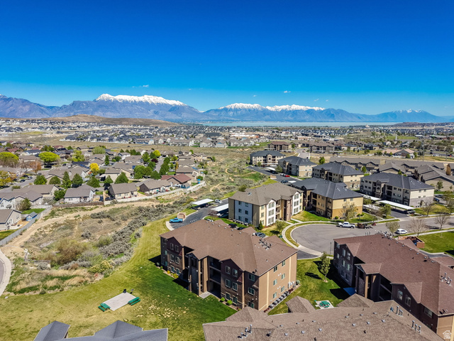 8215 Clear Rock Road, Unit 12 Eagle Mountain, UT 84005 - Photo 24 of 38 Expansive aerial view showcasing residential areas with distant snow-capped mountains and a body of water