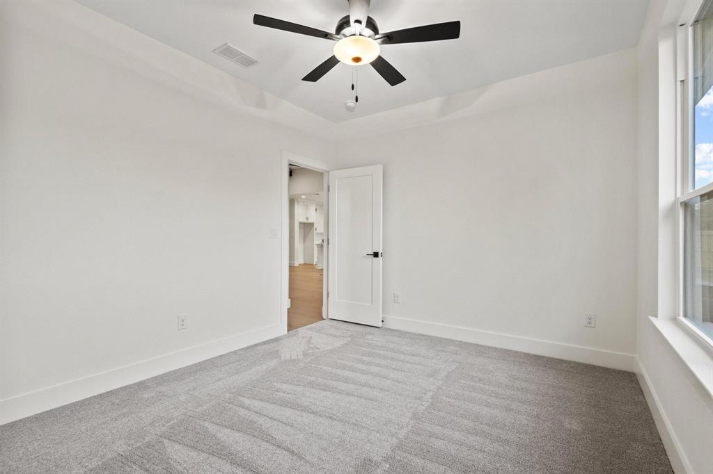4605 Dripping Spring Road Sherman, TX 75090 - Photo 29 of 40 an empty room with chandelier fan