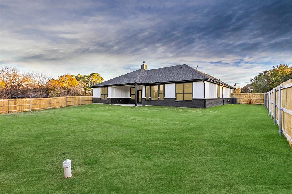 4605 Dripping Spring Road Sherman, TX 75090 - Photo 34 of 40 a front view of a house with garden