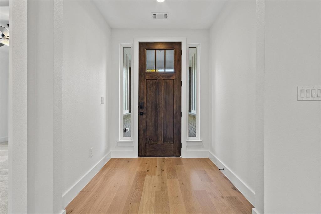 4605 Dripping Spring Road Sherman, TX 75090 - Photo 5 of 40 a view of an empty room with wooden floor and closet