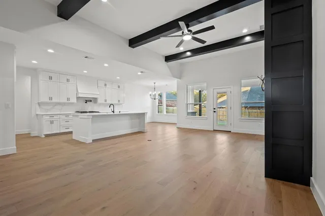 a view of a kitchen with a refrigerator a microwave and a sink