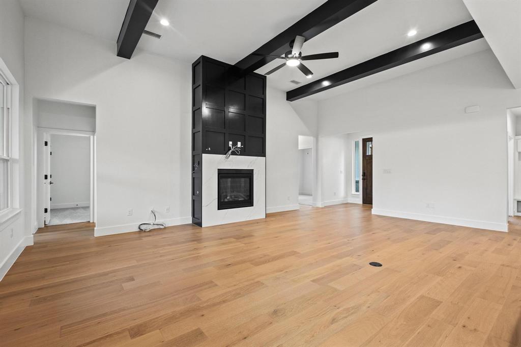 4605 Dripping Spring Road Sherman, TX 75090 - Photo 8 of 40 a view of an empty room with a fireplace and a fan