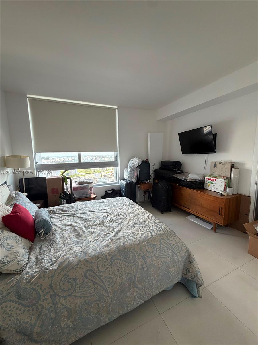 90 Southwest 3rd Street, Unit 4006 Miami, FL 33130 - Photo 13 of 19 a bedroom with bed and a window