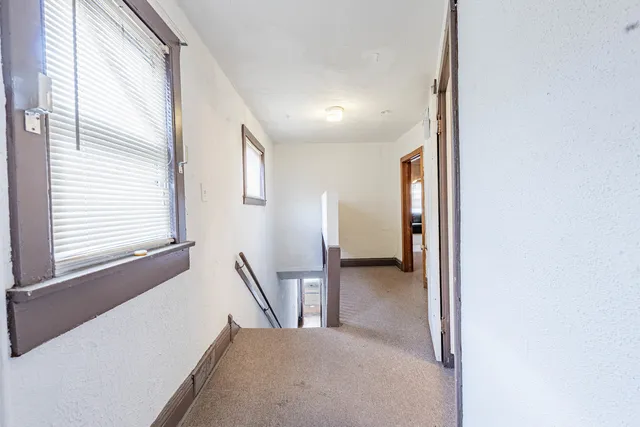 a view of a hallway with windows