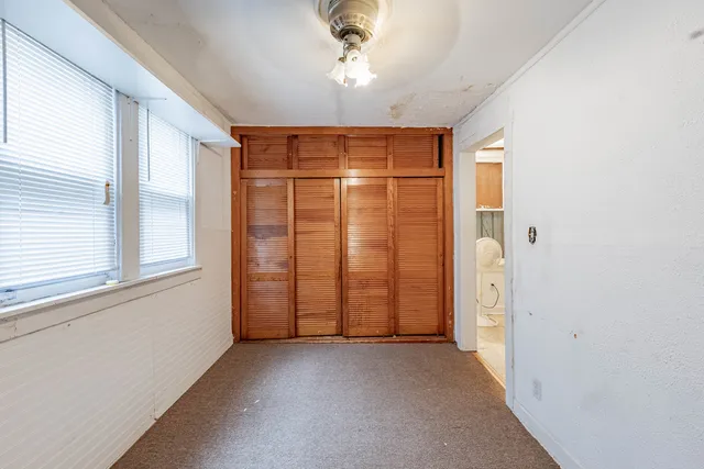 an empty room with a empty space and windows