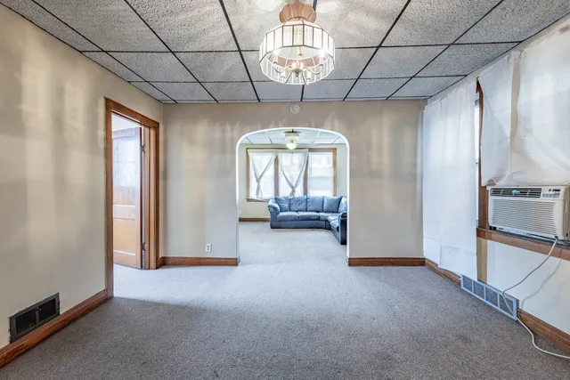 a view of a livingroom with a furniture wooden floor and windows