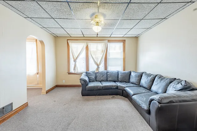 a living room with furniture and a chandelier