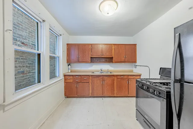 a kitchen with stainless steel appliances granite countertop a stove a sink and a refrigerator