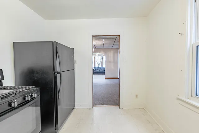 a kitchen with a refrigerator and a stove