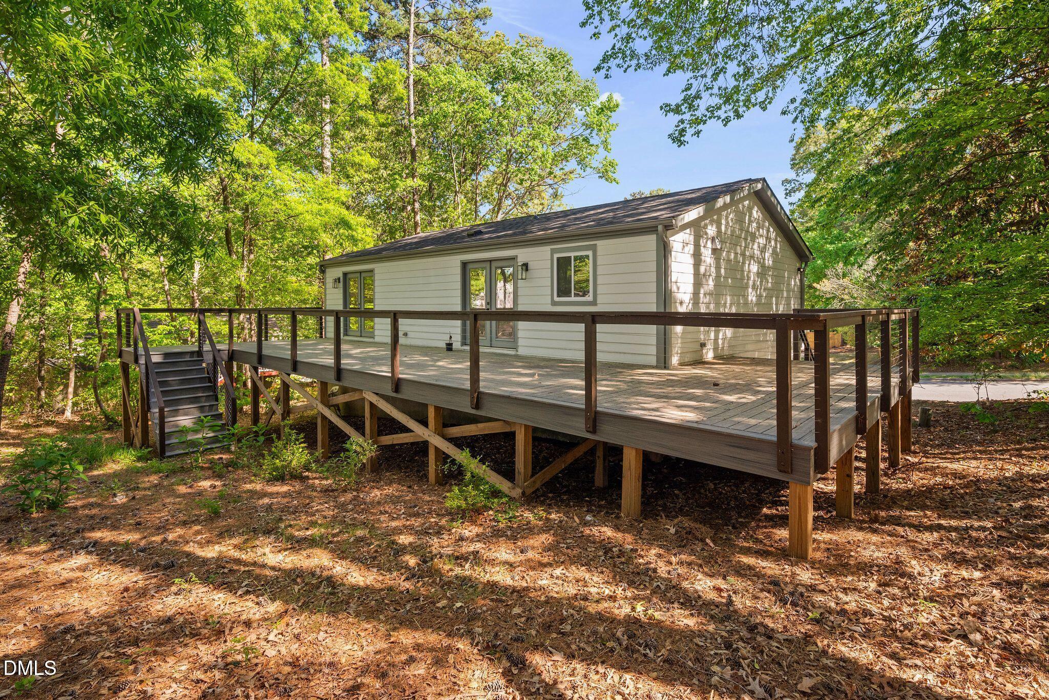 313 Crown Oaks Drive Raleigh, NC 27615 - Photo 39 of 60 a view of a house with backyard wooden fence and trees
