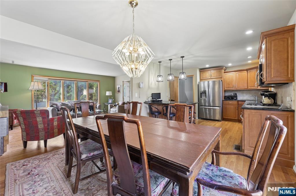 35 Robin Road Wayne, NJ 07470 - Photo 13 of 37 a view of a dining room with furniture a chandelier and wooden floor