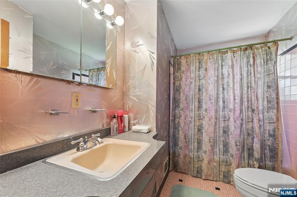 35 Robin Road Wayne, NJ 07470 - Photo 18 of 37 a bathroom with a sink vanity mirror and toilet