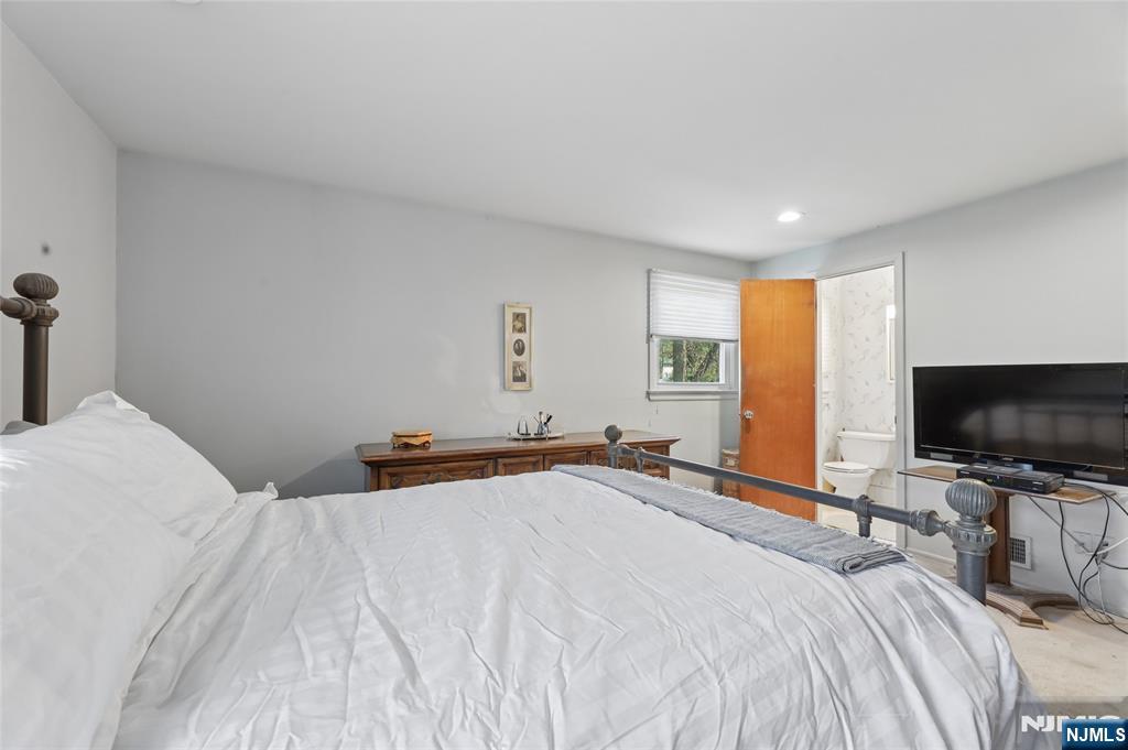 35 Robin Road Wayne, NJ 07470 - Photo 23 of 37 a bedroom with a bed and a flat screen tv