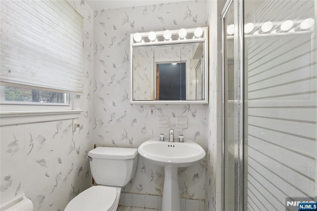 35 Robin Road Wayne, NJ 07470 - Photo 24 of 37 a bathroom with a sink and mirror with toilet