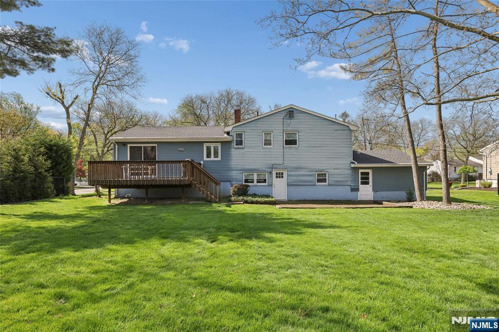 35 Robin Road Wayne, NJ 07470 - Photo 32 of 37 a front view of a house with a garden and trees