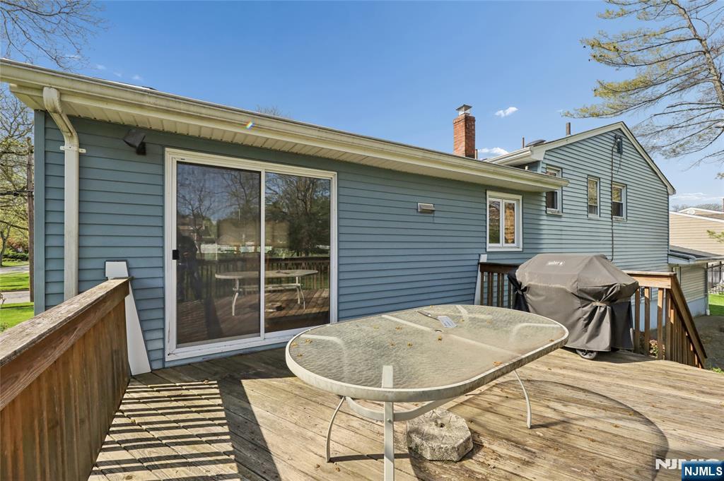 35 Robin Road Wayne, NJ 07470 - Photo 33 of 37 a view of a patio with table and chairs and wooden floor