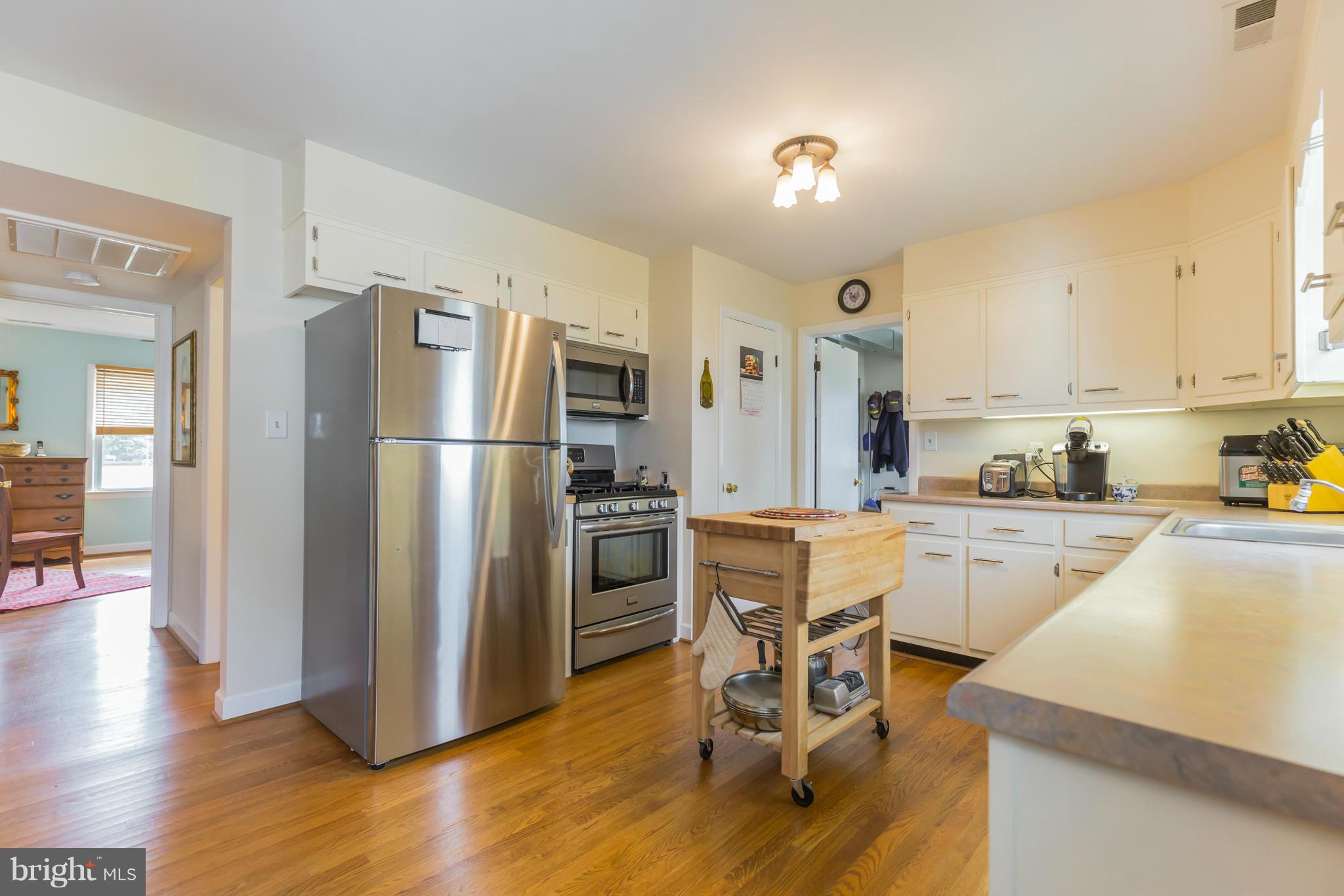 16237 Millers Wharf Road Ridge, MD 20680 - Photo 14 of 29 a kitchen with a refrigerator a counter top space and cabinets