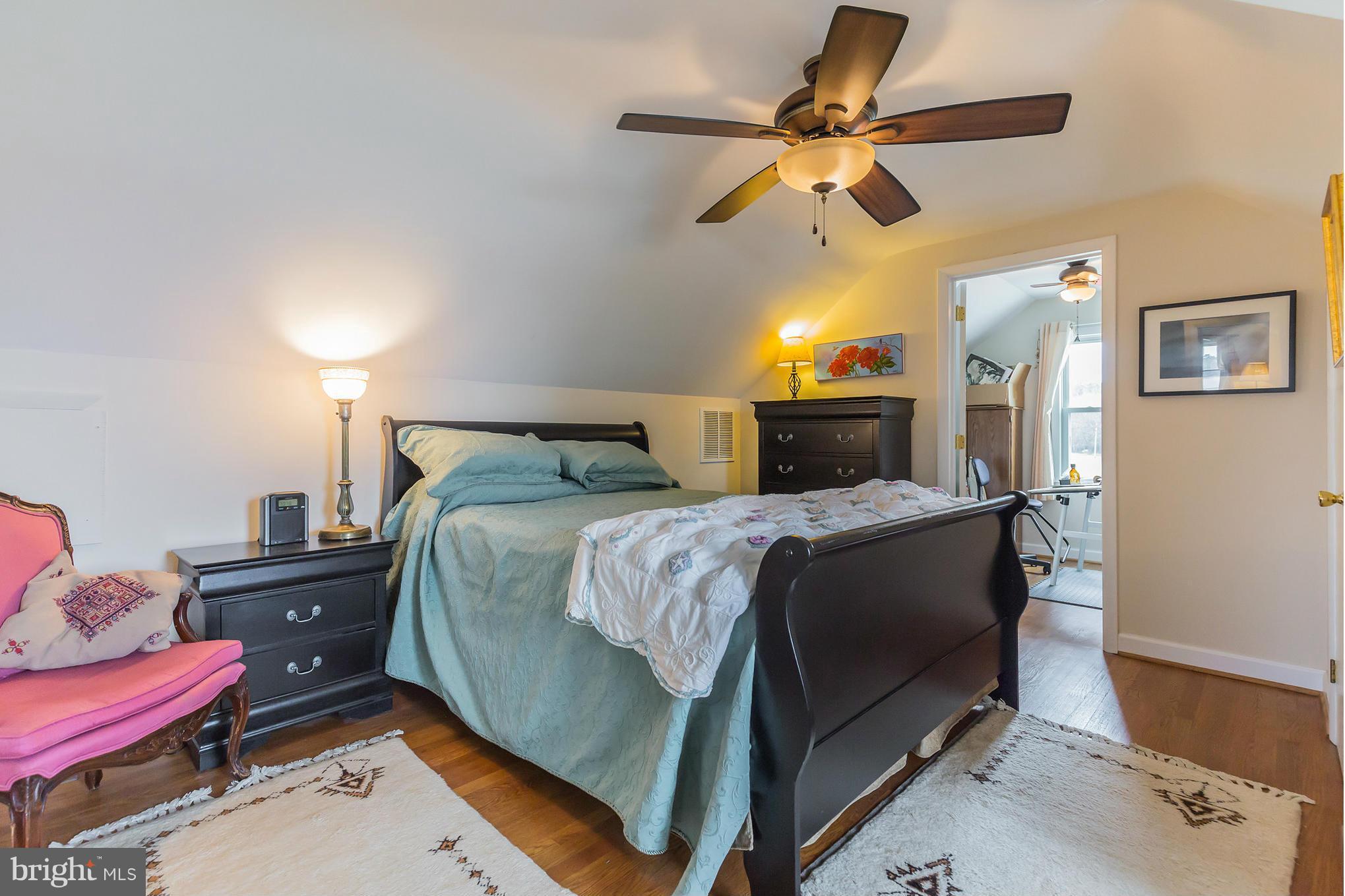 16237 Millers Wharf Road Ridge, MD 20680 - Photo 23 of 29 a bedroom with a bed and a chandelier