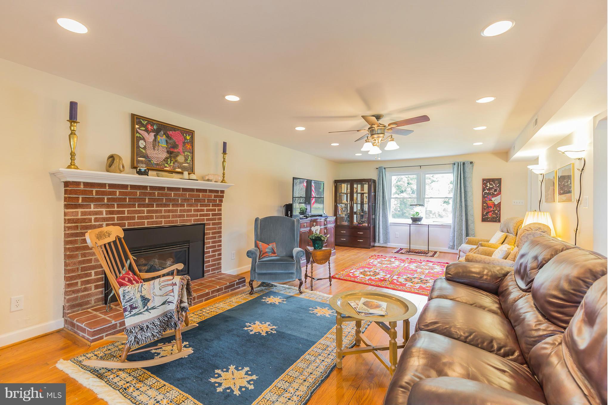 16237 Millers Wharf Road Ridge, MD 20680 - Photo 6 of 29 a living room with furniture and a fireplace