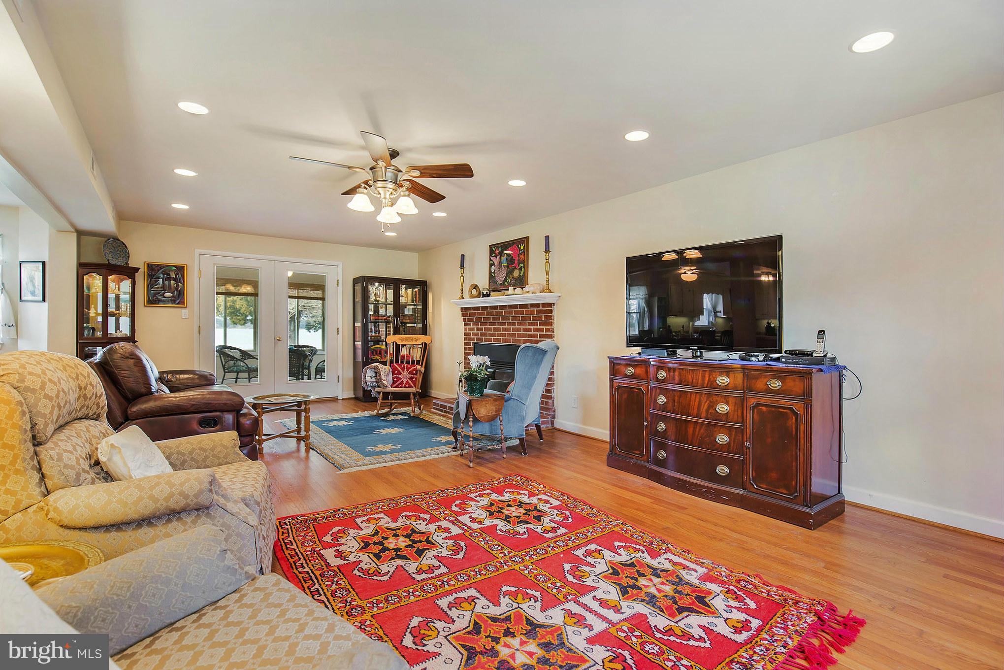 16237 Millers Wharf Road Ridge, MD 20680 - Photo 9 of 29 a living room with furniture and a flat screen tv