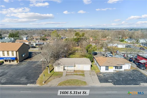 an aerial view of residential houses with outdoor space