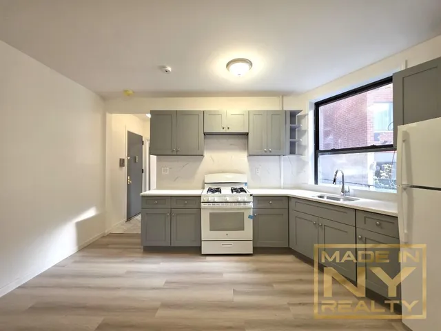 a kitchen with stainless steel appliances granite countertop a stove and a sink