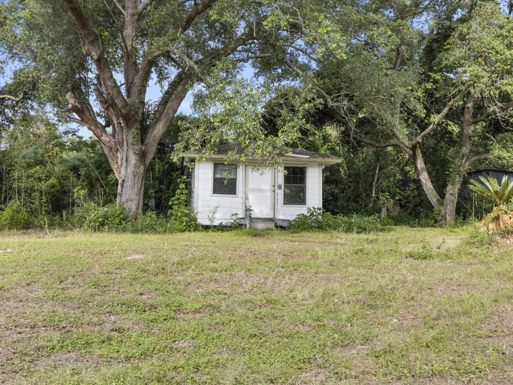 5714 Masters Manvel, TX 77578 - Photo 23 of 43 a backyard of a house with plants and large tree