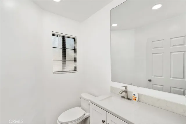 a bathroom with a sink toilet and vanity