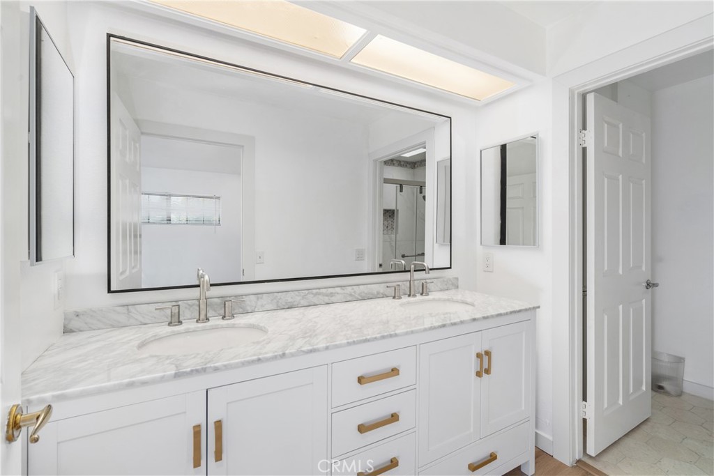 18435 Keswick, Unit 10 Reseda, CA 91335 - Photo 23 of 34 a bathroom with a granite countertop sink and a mirror