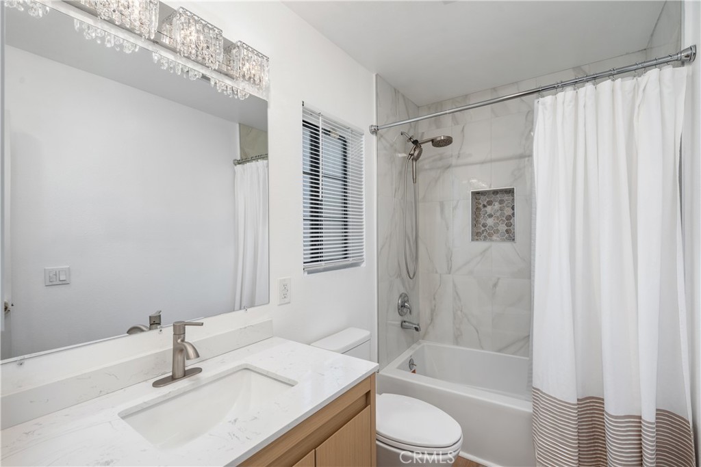 18435 Keswick, Unit 10 Reseda, CA 91335 - Photo 29 of 34 a bathroom with a granite countertop sink toilet and shower