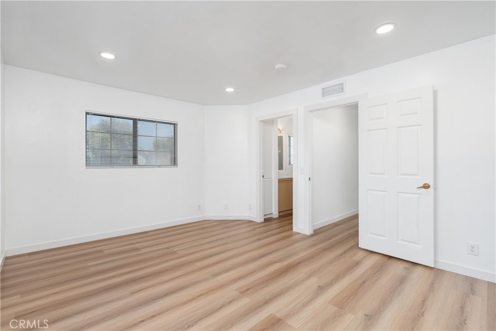 18435 Keswick, Unit 10 Reseda, CA 91335 - Photo 32 of 34 a view of an empty room with wooden floor and a window