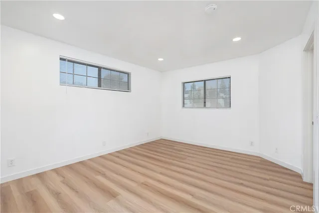 a view of a room with wooden floor and white walls