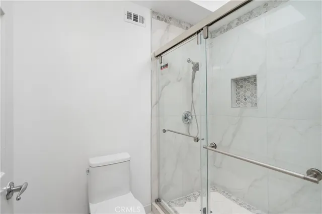 a bathroom with a shower and toilet