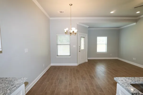 a view of a kitchen with a sink and a window