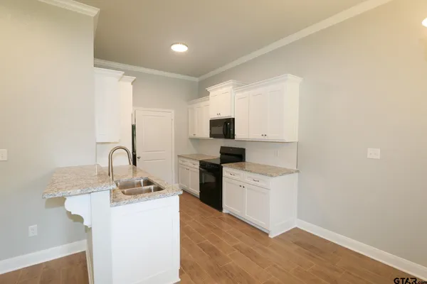 a kitchen with a sink and refrigerator