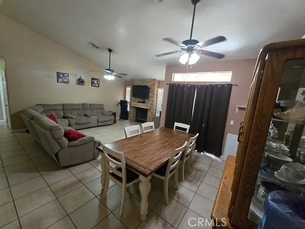 a living room with furniture a ceiling fan and a rug