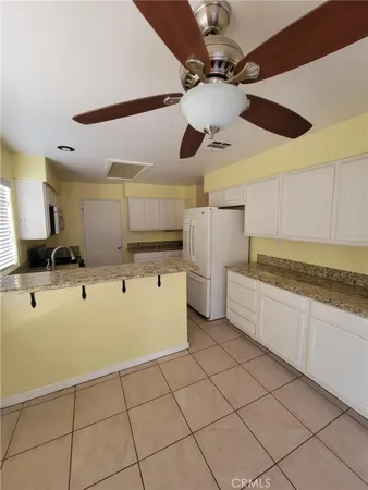 a kitchen with stainless steel appliances kitchen island granite countertop a sink and cabinets